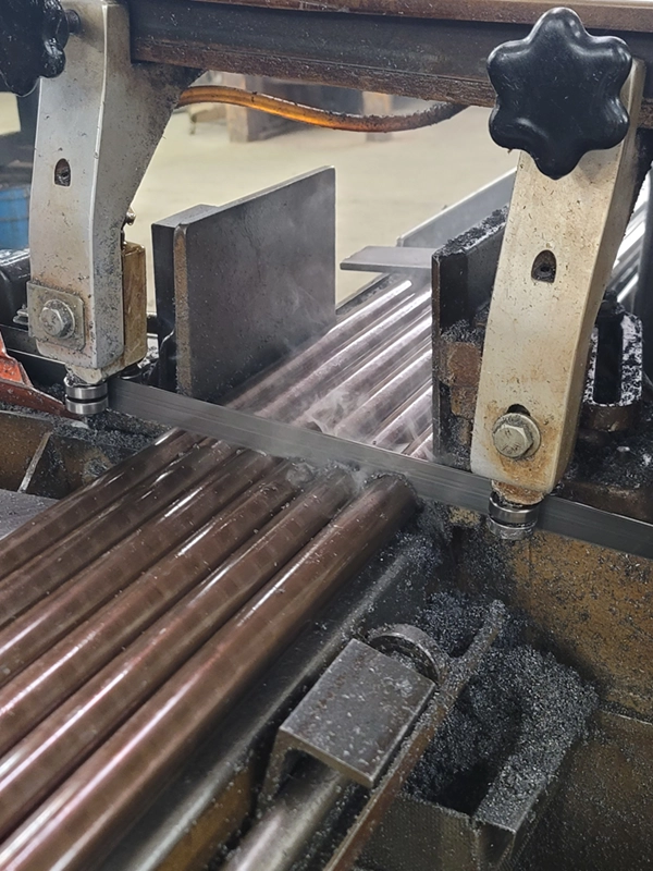 Barrels being sawed by a machine