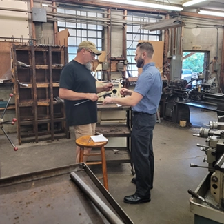 A customer is being shown around our facility. The customer is interested in learning about our manufacturing process.